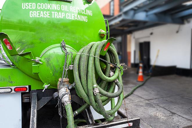 a service truck pumping grease from a restaurant's grease trap in Calcutta